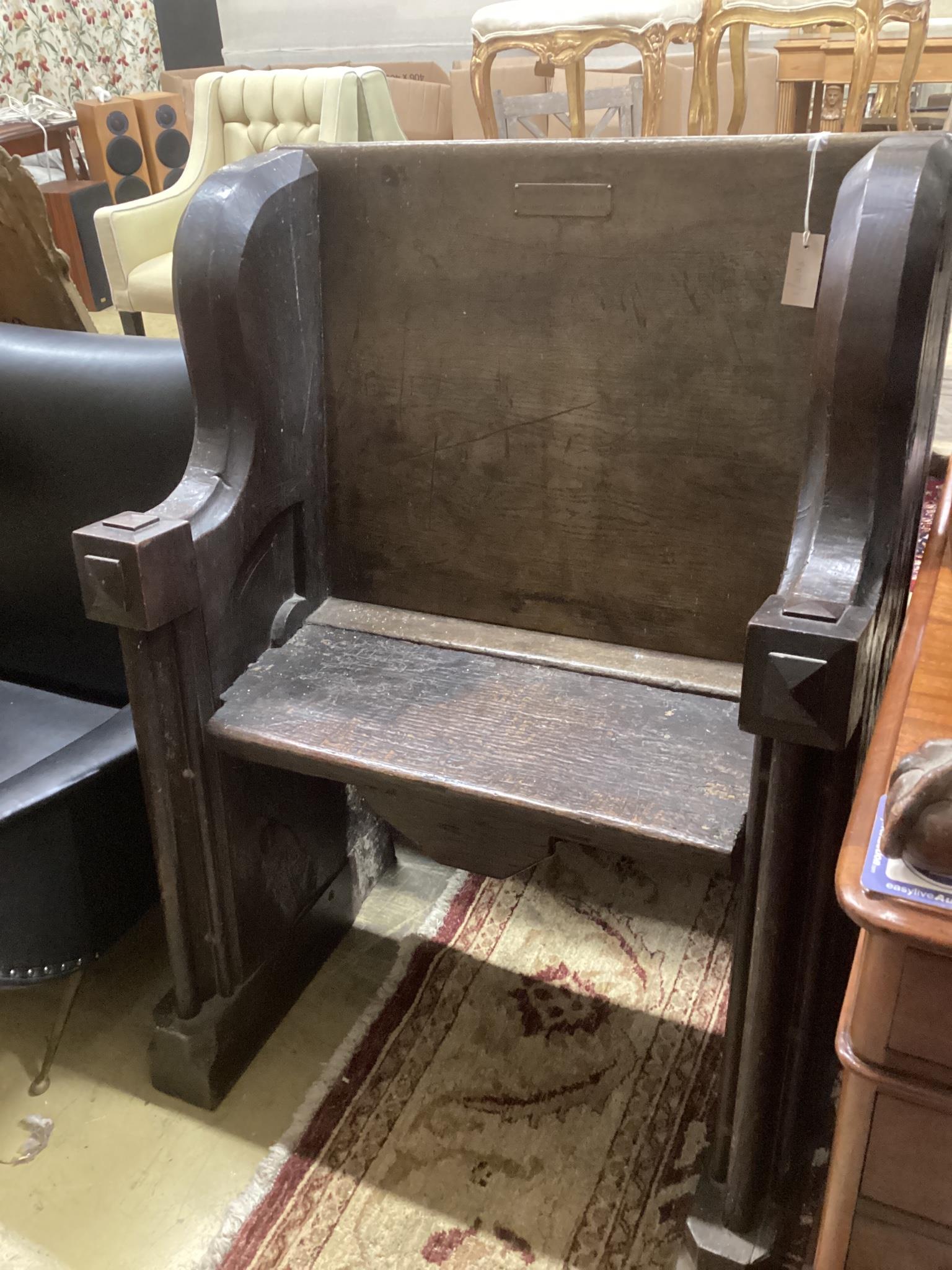 A 17th century and later oak pew with carved misericord, width 82cm, depth 40cm, height 109cm